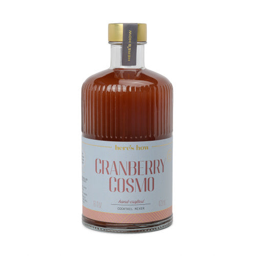 Fluted glass bottle with gold foil label containing cranberry cocktail mixer