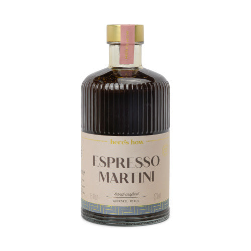 Clear fluted glass bottle with gold foil label containing espresso martini cocktail mixer
