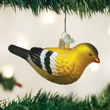 American Goldfinch glass ornament with yellow body, black wings, red face patch, and green tail feathers.