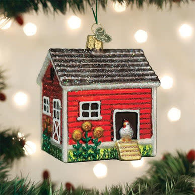 Small chicken coop ornament in natural wood finish with a pitched roof and cutout windows.