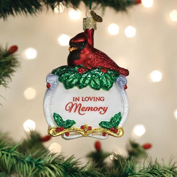 Red glass cardinal ornament with gold accents on a silver stand