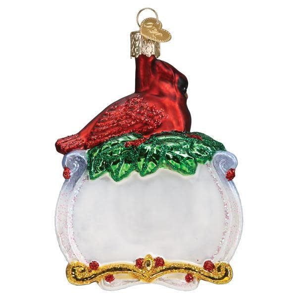 Red cardinal ornament with gold accents on a white background