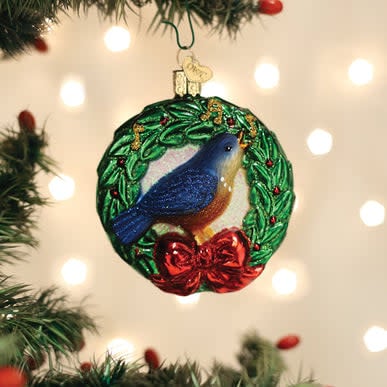 Calling Bird ornament in natural wood finish with carved bird silhouette perched on a branch.