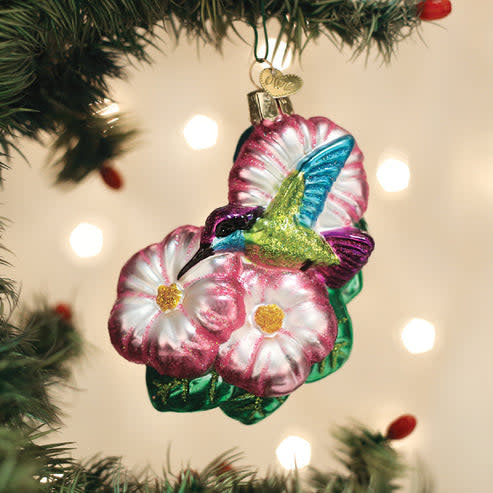 Blue glass hummingbird ornament with gold accents on a silver stand
