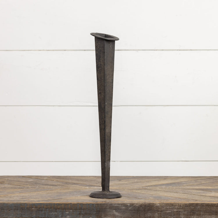 Black metal tapered vase with a sleek minimalist cylindrical shape.