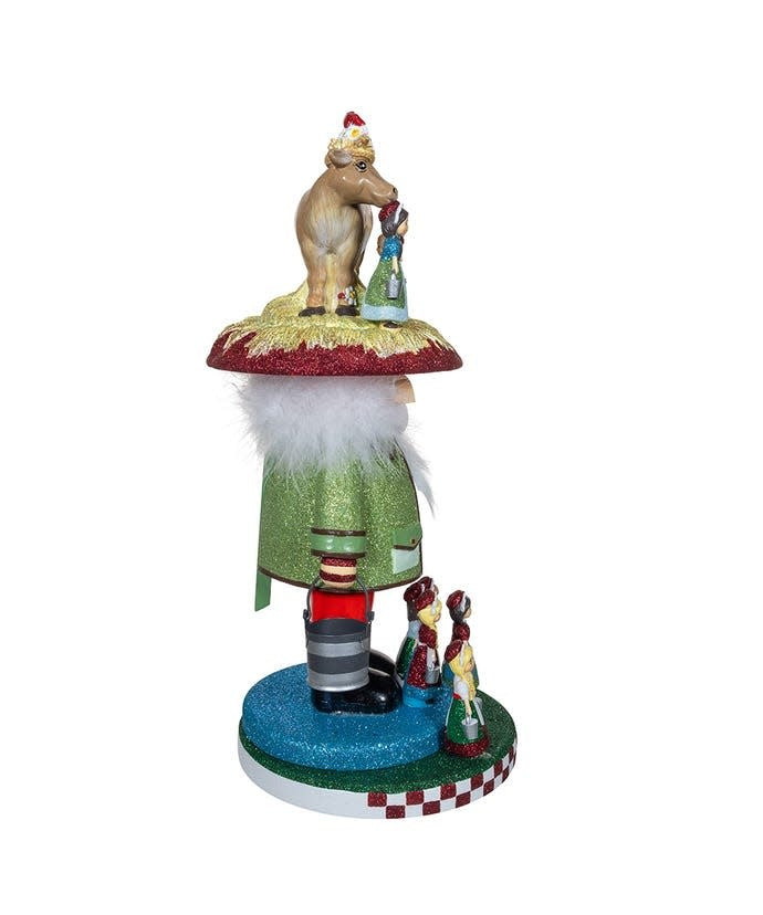 Wooden Hollywood nutcracker featuring eight maids in a milking pose with red and green festive colors.