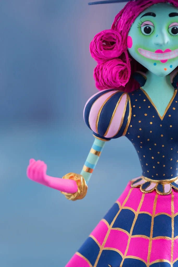 Hand-painted pink resin witch figurine with gold leaf accents standing 17 inches tall.