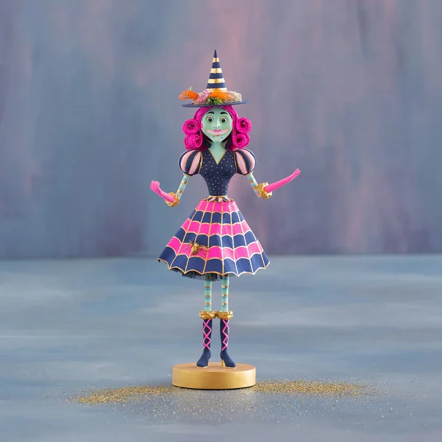 Hand-painted pink resin witch figurine with gold leaf accents standing 17 inches tall.