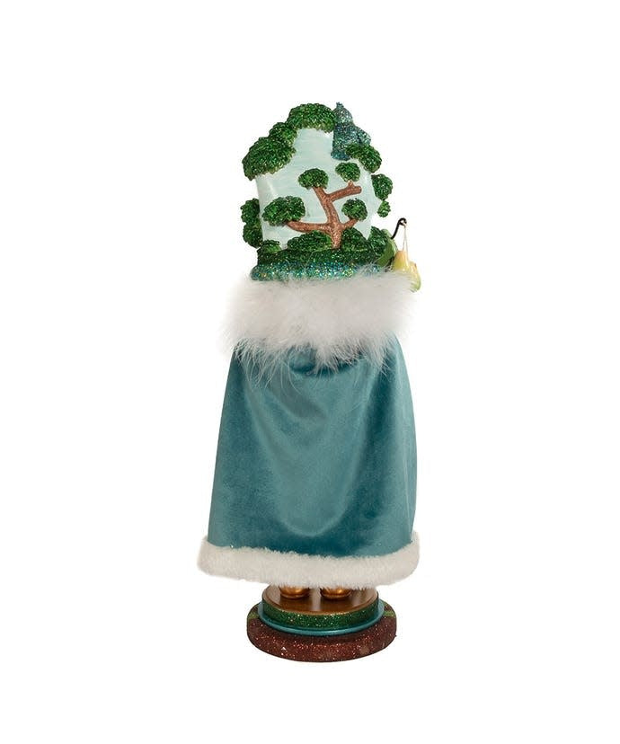 Wooden nutcracker shaped as a tree with five linked golden rings and red bows on top.
