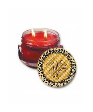 A large white ceramic jar containing a creamy candle with visible wicks.