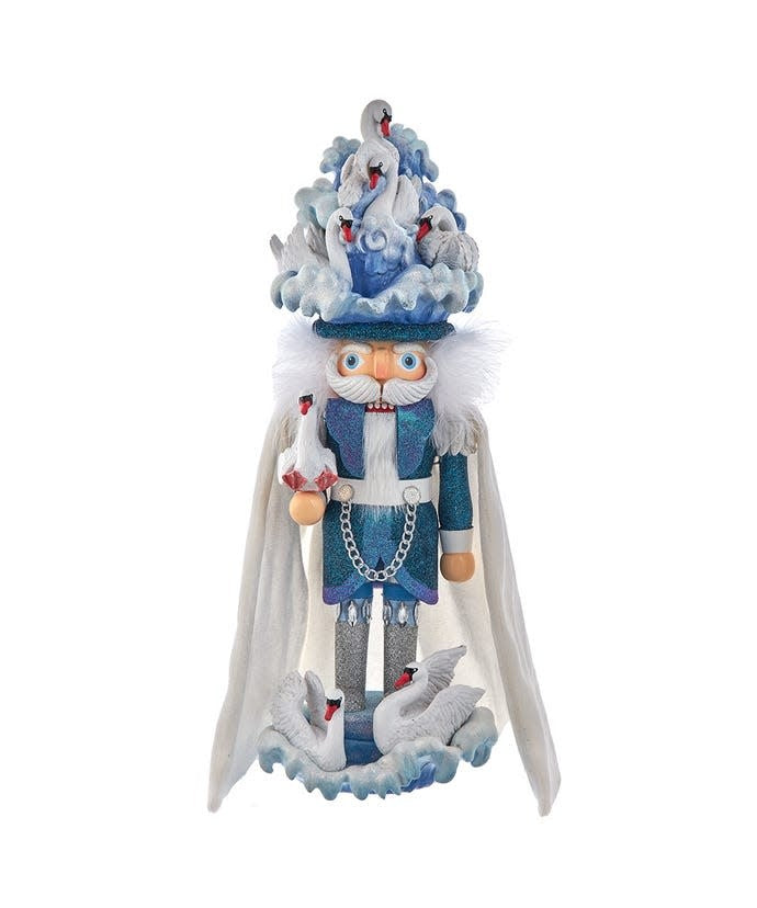 Wooden nutcracker figure with seven swans on a blue glittered water base.