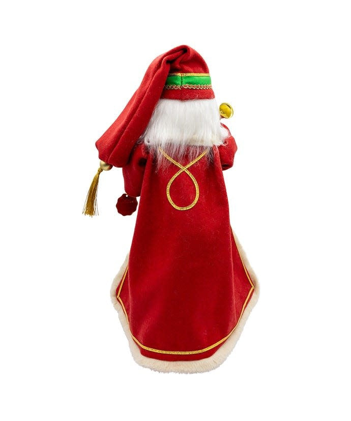 Wooden nutcracker figure of Santa in red with fur trim holding a staff against dark background