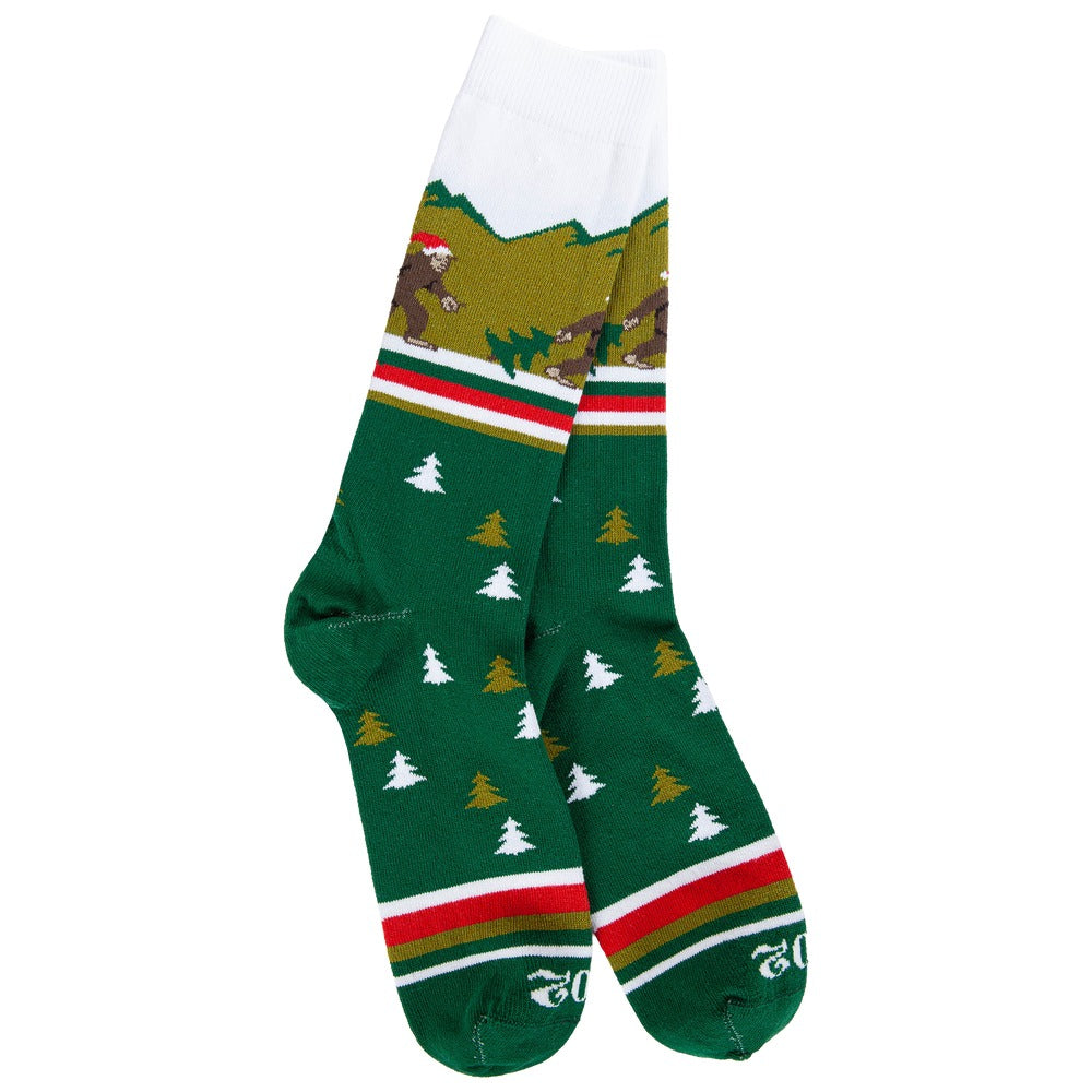 Green crew socks with white and gold trees, featuring a Santa Sasquatch in a mountain landscape.