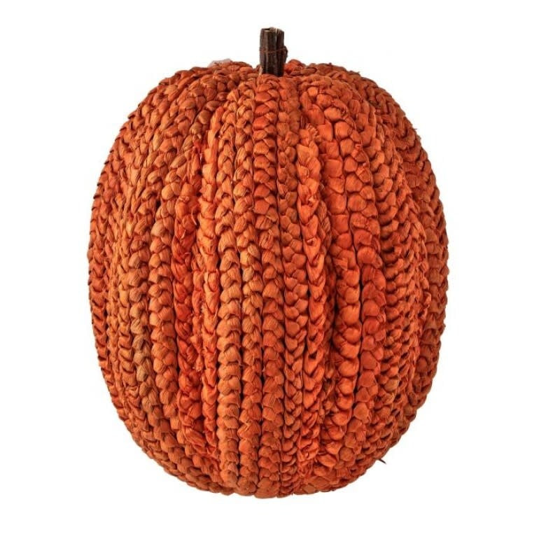 Basket weave pumpkin display with twig stem in natural corn husk tones