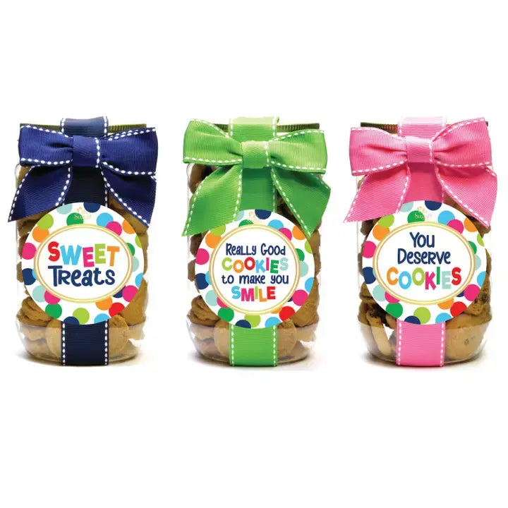 Glass jar filled with chocolate chip cookies featuring a polka dot pattern on the label.