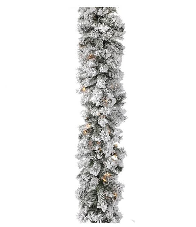 Green furry pine garland with white flocking and warm clear LED lights