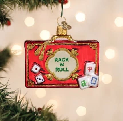 Mahjong tile rack ornament with a vintage green felt surface holding four red-and-white tiles.