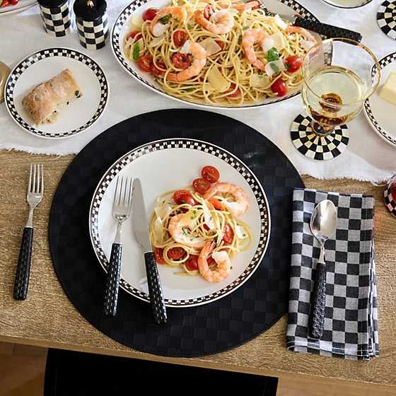 Four woven jacquard check napkins made from cotton with a classic plaid pattern.