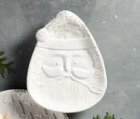 White glazed stoneware platter with antique wash finish featuring a raised Santa face silhouette and textured surface.