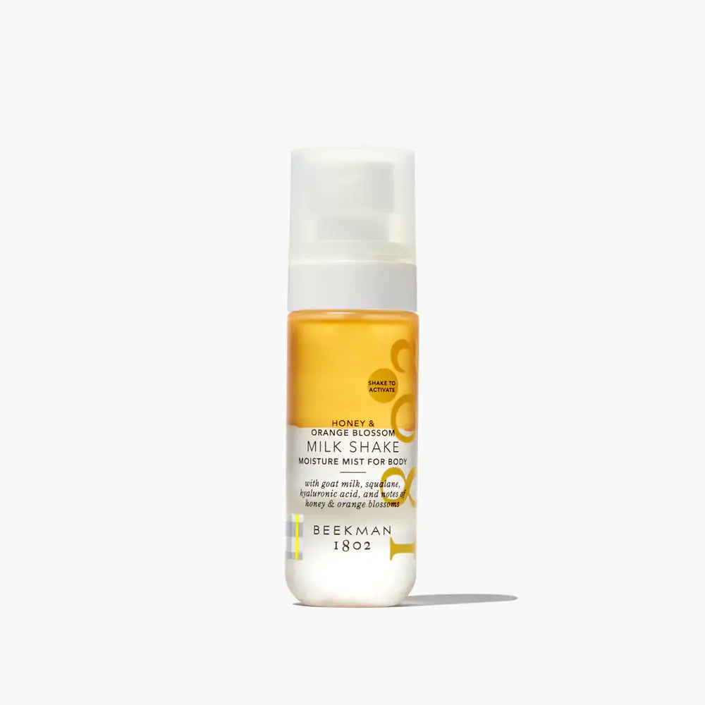 Honey & Orange Blossom Body Milk Shake in a white bottle with orange accents