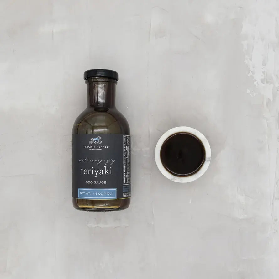 Bottle of Teriyaki BBQ Sauce with a label featuring soy sauce base ingredients like sake and pineapple.