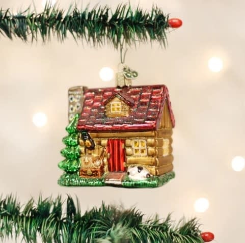 Glass Lake Cabin ornament in blue with white roof detailing