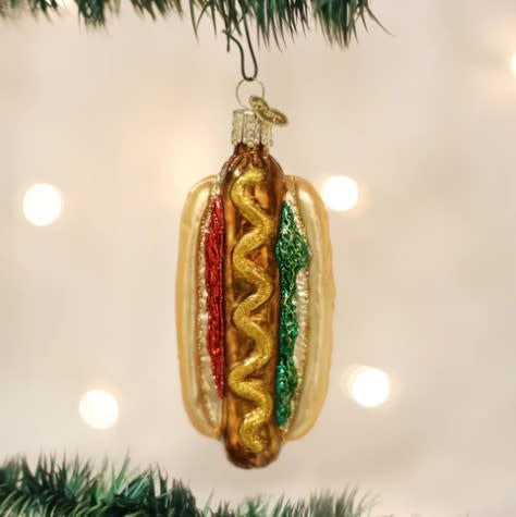 Red hot dog sausage ornament with mustard on a bun