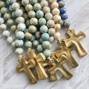 Long blessing beads with a dark dim cross hanging from an attached card.