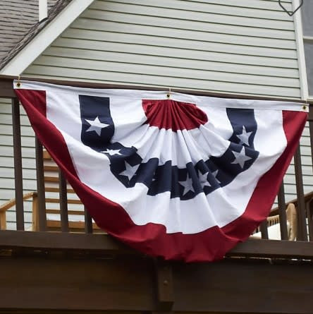 American flag bunting made of cotton with metal grommets along the top edge.