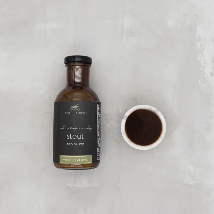 Bottle of dark stout BBQ sauce with a black label featuring white text.