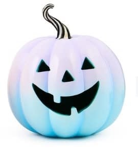 Illuminated jack o' lantern with a carved pumpkin face glowing from within.
