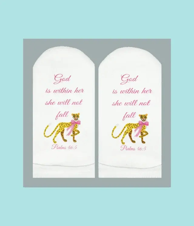 White crew socks with black text reading 'She Will Not Fall' from Psalms 46:5.