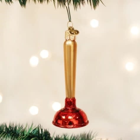 Toilet plunger ornament with a black rubber cup on a white handle.