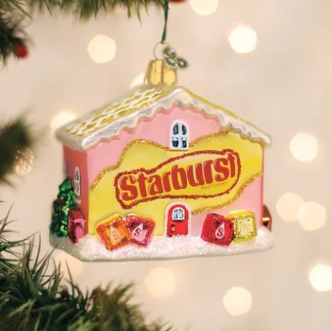 Red starburst-shaped cottage ornament with white accents.