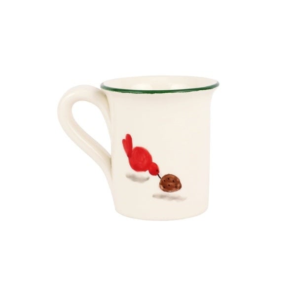 White ceramic mug featuring Old St. Nick pouring sugar with a red bird friend against a kitchen backdrop.