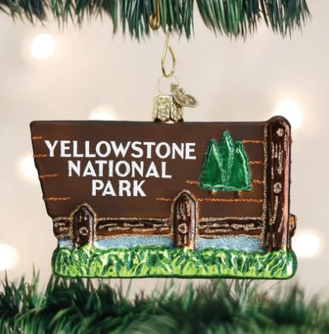 Yellowstone National Park ornament featuring a scenic landscape with geysers in gold-toned metal.