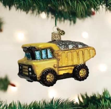 Toy dump truck ornament with red body, black wheels, silver bed liner, and yellow cab.