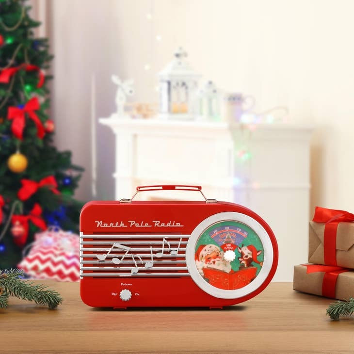 Vintage red North Pole Radio with retro speaker grille and antenna.