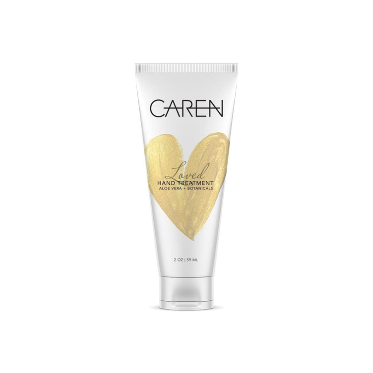 A bottle of Loved Hand Treatment in Timeless with a woody scent.