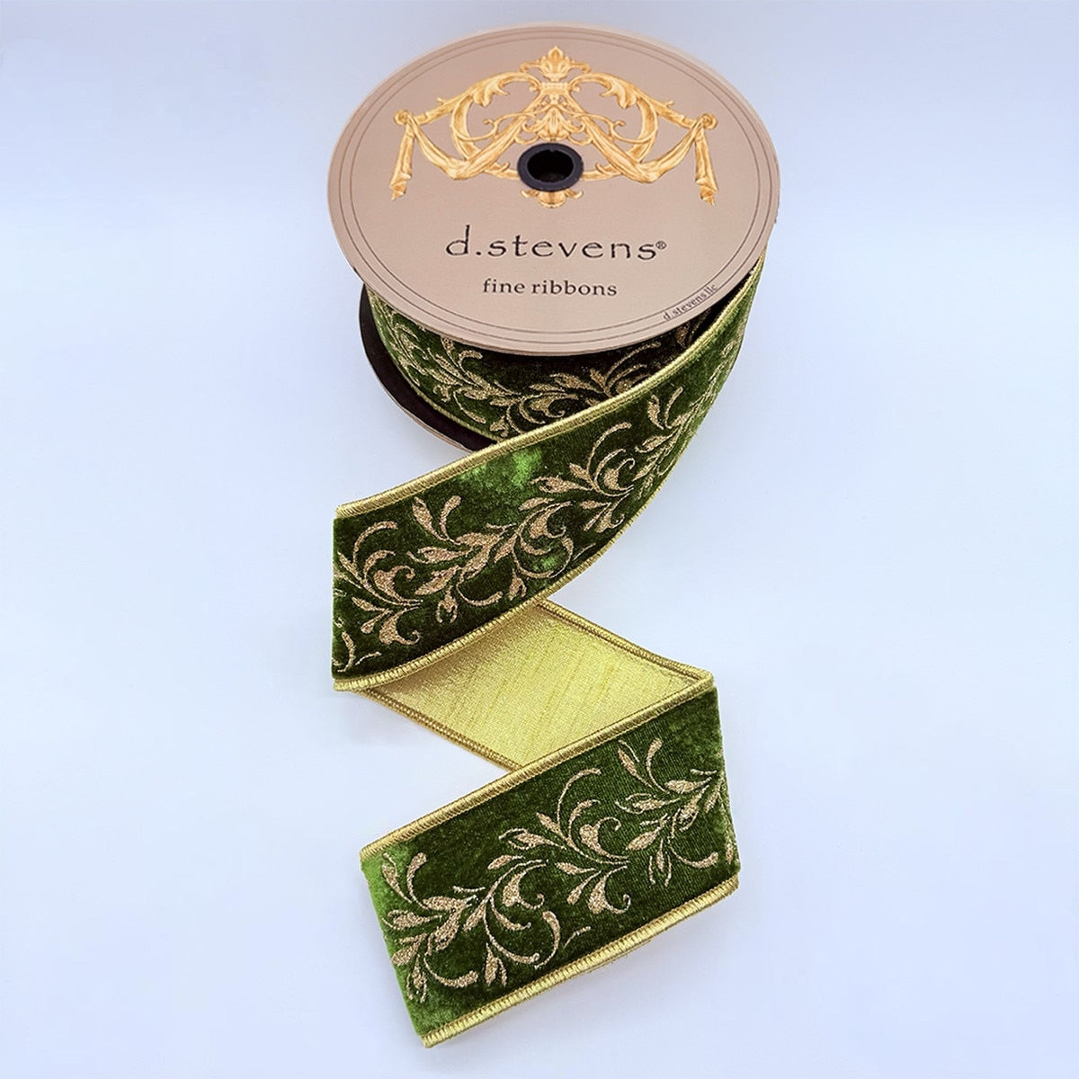 2.5 inch moss green velvet ribbon with gold glitter Angel's trumpet pattern on a spool.