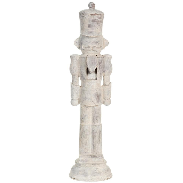 Beige antique nutcracker with traditional silhouette standing on a base.