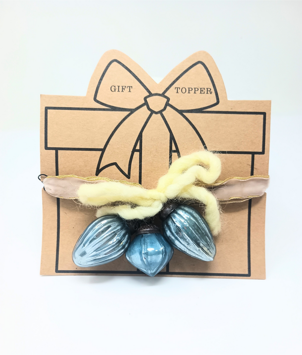 Glass ornament gift topper with festive decorative shape