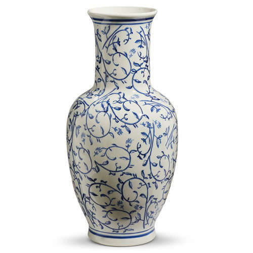 Tall ceramic vase with a blue and white geometric pattern on its cylindrical silhouette.