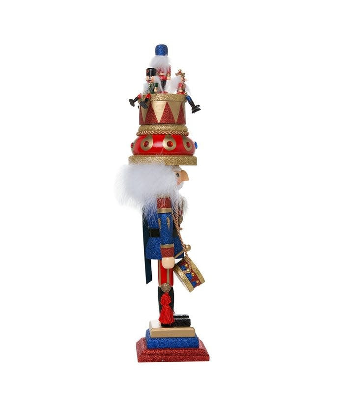 Wooden nutcracker in blue, red, and gold with a music box hat playing the Nutcracker Suite.