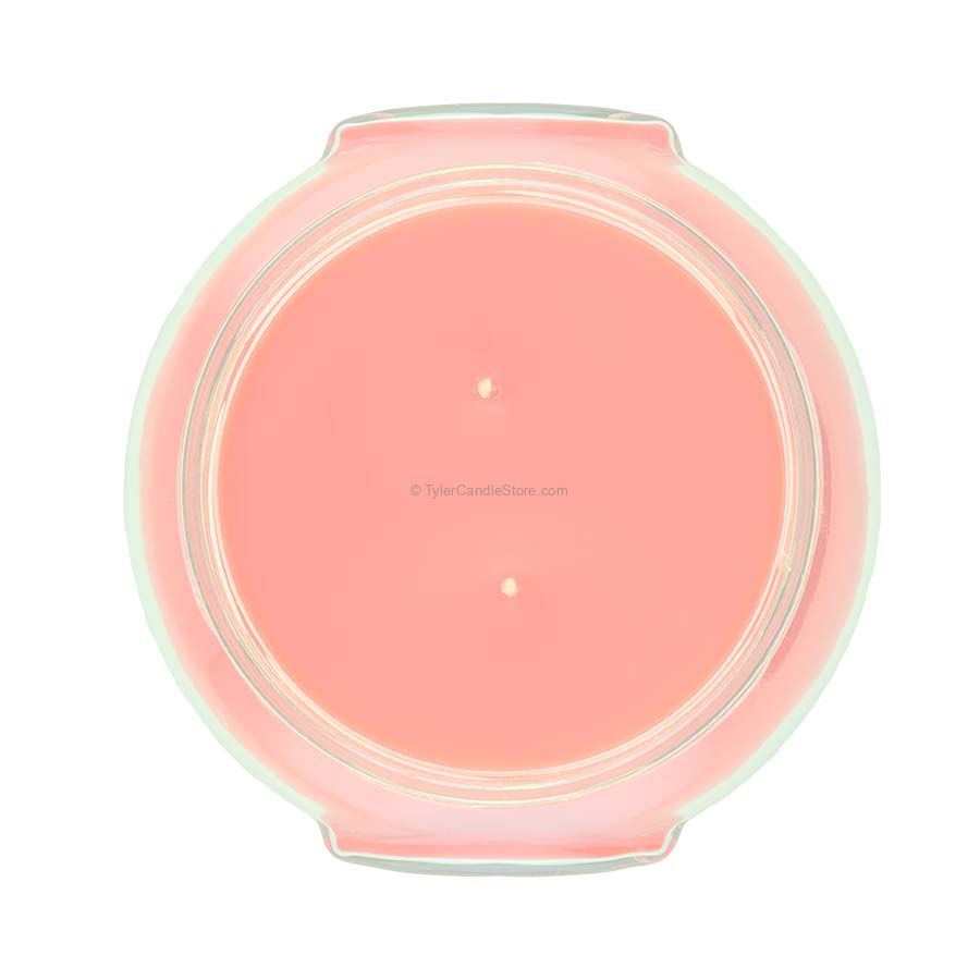 A clear glass jar containing a Mediterranean Fig scented candle with visible wicks.