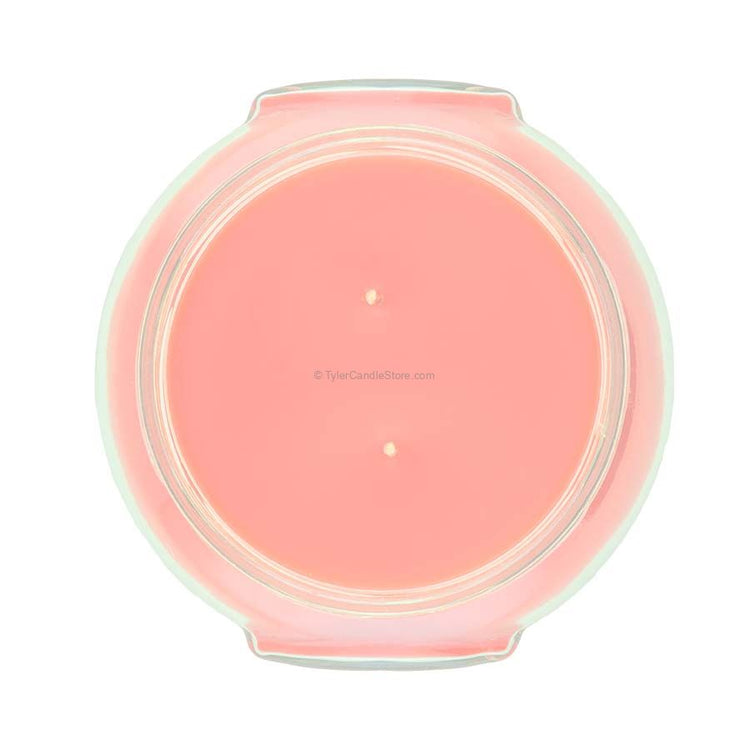 A clear glass jar containing a Mediterranean Fig scented candle with visible wicks.