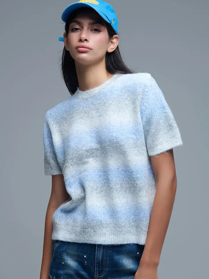 Model wearing the Maine Short Sleeve Ombre Striped Sweater in blue and white with a blue cap.