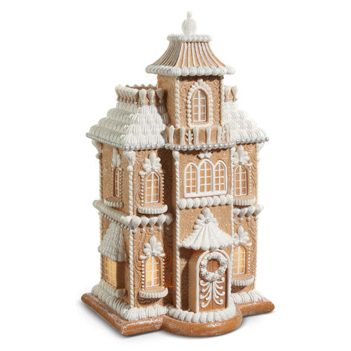 Resin gingerbread house with lighted windows in a traditional shape