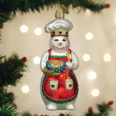 Glass snow woman chef ornament in white with silver accents holding a cookie bowl