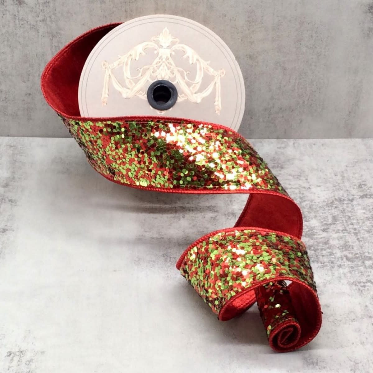 A roll of 2.5-inch wide ribbon featuring red and lime green glitter sequins on a red velvet base.